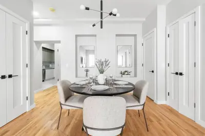 a dining room with a table and chairs at Top Notch 2BR in Upper East Mins to Central Park in New York