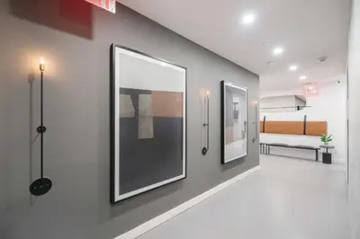 a hallway with two large framed pictures on a wall at Top Notch 2BR in Upper East Mins to Central Park in New York