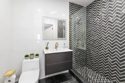 a bathroom with a sink and a toilet and a mirror at Top Notch 2BR Suite Minutes to Central Park in New York