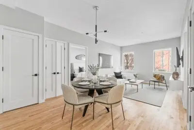 a white living room with a table and chairs at Top Notch 2BR Suite Minutes to Central Park in New York