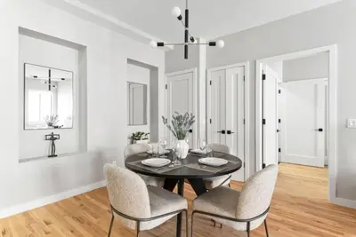 a dining room with a black table and chairs at Top Notch 2 Bedroom Minutes From Central Park in New York