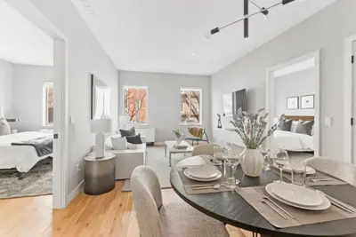 a dining room and living room with a table and chairs at Top Notch 2 Bedroom Minutes From Central Park in New York