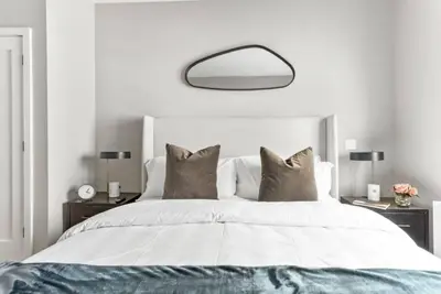 a bedroom with a large white bed with pillows at Top Notch 2 Bedroom Minutes From Central Park in New York