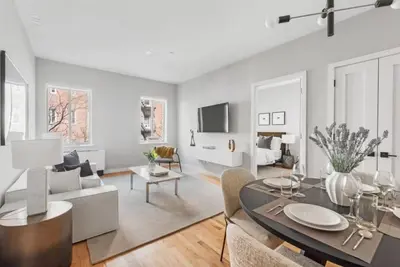 a living room with a dining table and a couch at Top Notch 2 Bedroom Minutes From Central Park in New York