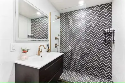 a bathroom with a sink and a shower at Luxury 3BR Duplex w Private Patio in Upper East in New York