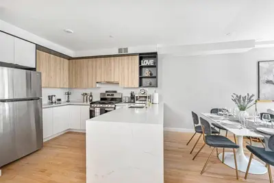 a kitchen and dining room with a table and chairs at 3BR Penthouse Suite with Massive Private Rooftop in New York