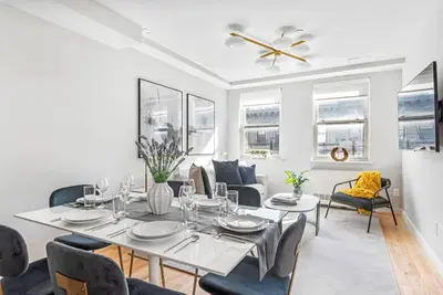 a white dining room with a table and chairs at 3BR Penthouse Suite with Massive Private Rooftop in New York