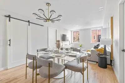a dining room with a table and some chairs at 3BR Penthouse with Massive Private Rooftop in New York