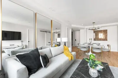 a living room with a couch and a dining room at 3BR Penthouse with Massive Private Rooftop in New York
