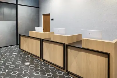 a lobby with three desks with laptops on them at DoubleTree by Hilton Long Island City, NY in Long Island City