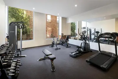 a gym with several treadmills and exercise bikes at DoubleTree by Hilton Long Island City, NY in Long Island City