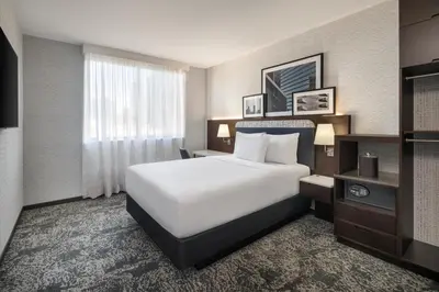 a hotel room with a bed and a window at DoubleTree by Hilton Long Island City, NY in Long Island City
