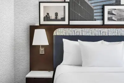 a hotel room with a bed and pictures on the wall at DoubleTree by Hilton Long Island City, NY in Long Island City