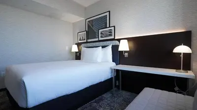 a hotel room with a large bed and a desk at DoubleTree by Hilton Long Island City, NY in Long Island City
