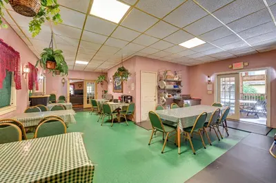 a restaurant with tables and chairs in a room at Lanesville Home with Pool Table, Bar and Deck! in Lanesville