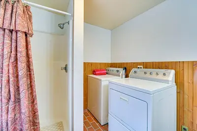 a laundry room with a washer and dryer at Lanesville Home with Pool Table, Bar and Deck! in Lanesville