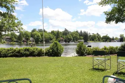 a park with a view of a lake and a playground at Waterfront Home on Bantam Lake with Private Beach in Morris