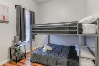 a bedroom with two bunk beds in a room at Gorgeous Duplex with parking by JSQ in Jersey City