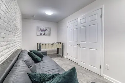 a living room with a couch and a door at Gorgeous Duplex with parking by JSQ in Jersey City