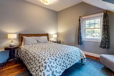 a bedroom with a bed and a window at Green Mountain Retreat in Sunderland