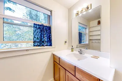 a bathroom with a sink and a window at Green Mountain Retreat in Sunderland