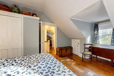 a bedroom with a bed and a desk and a window at Green Mountain Retreat in Sunderland