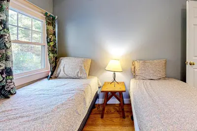 a bedroom with two beds and a lamp on a table at Green Mountain Retreat in Sunderland