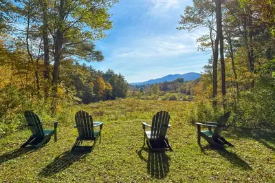 three chairs sitting in a field with a view at Green Mountain Retreat in Sunderland