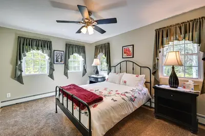 a bedroom with a bed and a ceiling fan at Quiet Killingworth Rental with Deck and Grill! in Deep River
