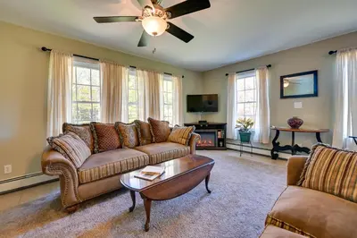 a living room with a couch and a table at Quiet Killingworth Rental with Deck and Grill! in Deep River