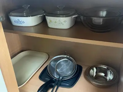 a shelf with bowls and utensils in a kitchen at Jersey home, close to New York City fun! in Englewood