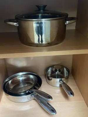 a pot and pans on a shelf in a kitchen at Jersey home, close to New York City fun! in Englewood