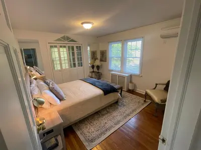 a bedroom with a bed and a chair in it at Jersey home, close to New York City fun! in Englewood