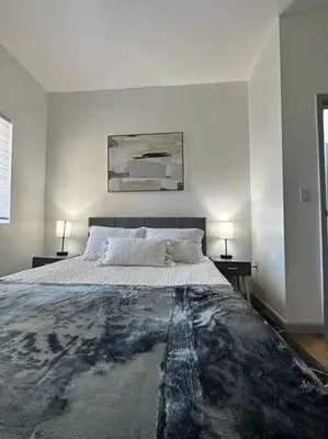 a bedroom with a large bed with two night stands at GREAT VALUE Stylish Queen Beds WD Free Park in Schenectady