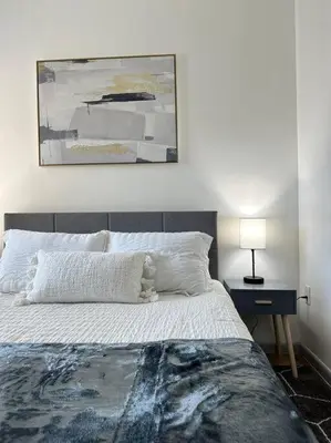 a bedroom with a bed and a painting on the wall at GREAT VALUE Stylish Queen Beds WD Free Park in Schenectady