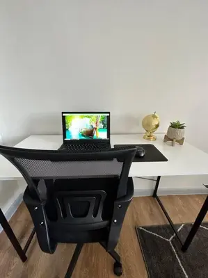 a laptop computer sitting on top of a white desk at GREAT VALUE Stylish Queen Beds WD Free Park in Schenectady