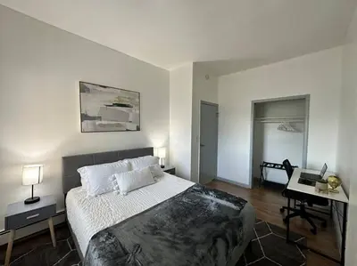 a bedroom with a bed and a desk in it at GREAT VALUE Stylish Queen Beds WD Free Park in Schenectady