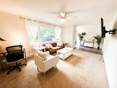 a living room with a couch and a chair at GREAT VALUE 7 Beds WD Parking in Albany