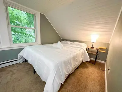a bedroom with a white bed and a window at GREAT VALUE 7 Beds WD Parking in Albany