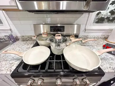 a stove top with two pans on top of it at GREAT VALUE 7 Beds WD Parking in Albany