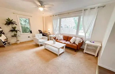 a living room with a couch and two chairs at GREAT VALUE 7 Beds WD Parking in Albany