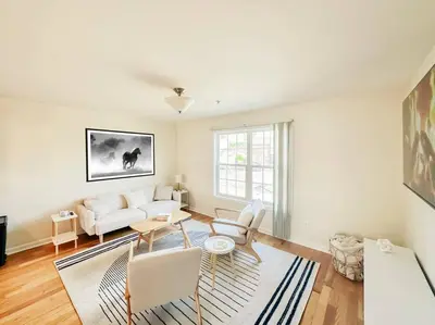 a living room with a white couch and a table at Luxury Style 2 King Bed WD FREE Garage in Schenectady