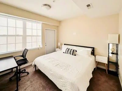 a bedroom with a bed and a desk and a chair at Luxury Style 2 King Bed WD FREE Garage in Schenectady