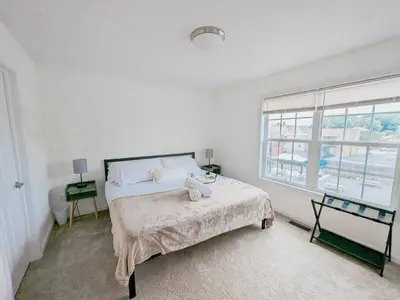 a white bedroom with a bed and a window at Luxury Stylish Townhome King Beds WD Garage in Schenectady