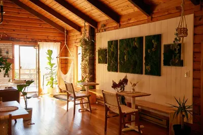 a room with tables and chairs and paintings on the wall at Sowilo All-inclusive Resort in Greenwich