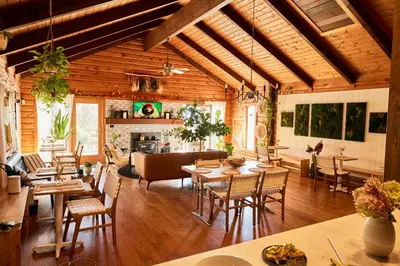 a living room with tables and chairs and a fireplace at Sowilo All-inclusive Resort in Greenwich