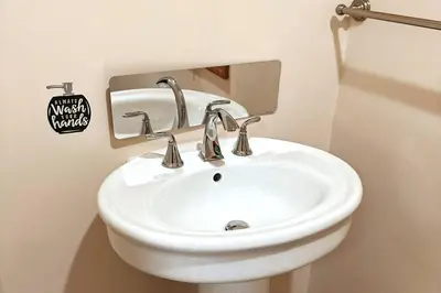 a bathroom with a white sink in a room at Private estate apartment. in Glen Head