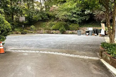 a parking lot with a bunch of benches and trees at Private estate apartment. in Glen Head