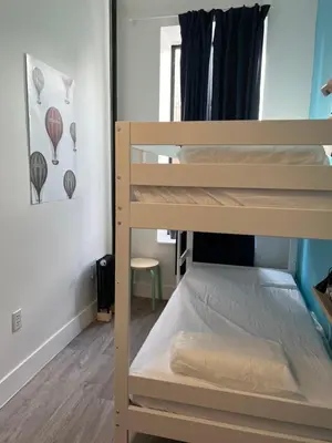 a bunk bed room with two bunk beds in a room at East Harlem Hostel in New York