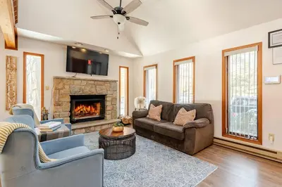 a living room with a couch and a fireplace at Cozy Cabin at Poconos With Hot Tub and Fire Pit in East Stroudsburg